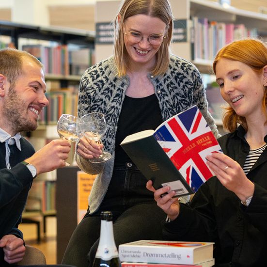 Bibliotekets litteraturformidlere skåler og kigger i en bog