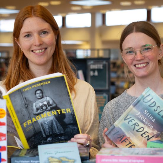 Bibliotekets litteraturformidlere Mette og Mette blandt en masse bøger