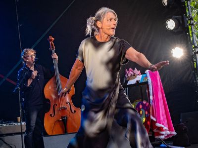 Kvinde på scene synger, i baggrunden mand der spiller kontrabas