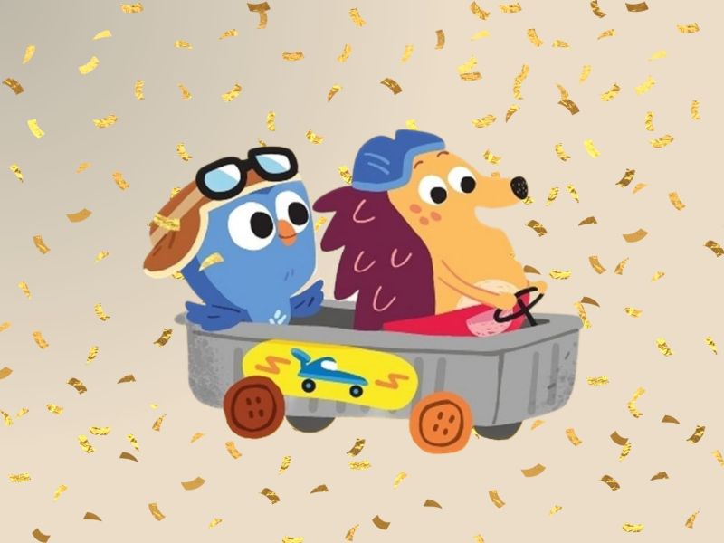 To animerede figurer - hvor den ene er Børste - sidder i en lille legetøjsbil med konfetti i baggrunden.